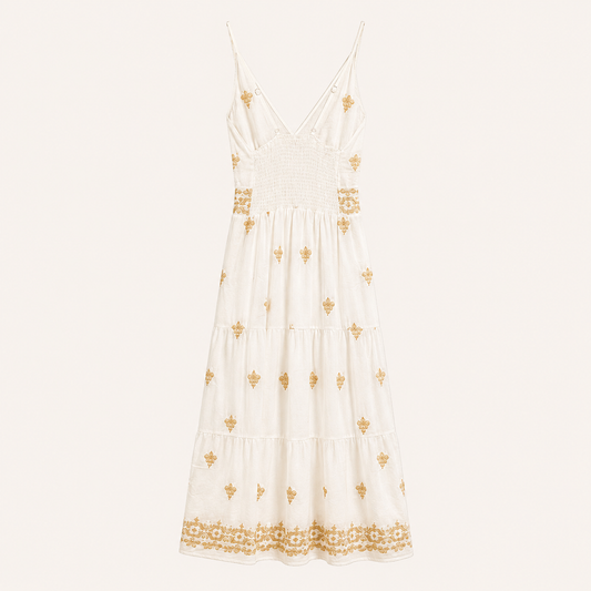 Abito lungo bianco panna con ricami beige, corpino arricciato e balze